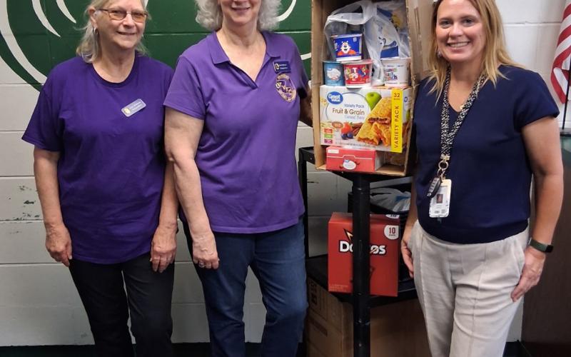 WVFC members, Jean Johnson and Jean Hebert deliver donations to a Ponchatoula High School Administrator. (Courtesy photo)