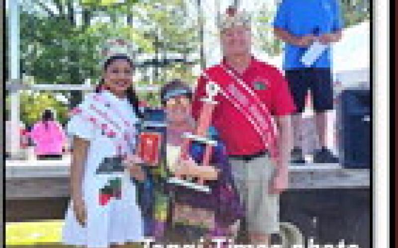 At right, Best in Show in the Julian Dufreche Strawberry Day in the Park car show was Bonnie Wills with her classic hippychick VW Bus. Car show coordinator Jody Borne (on stage, right) announced the winners in the show, which featured almost 100 classic cars and custom vehicles.