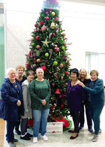 Members of the Gardenettes met December 3 at North Oaks Medical Center for their annual Christmas Tree trimming. Shown are Ellen Pusey, Carol McGough, Karen Hotard, Susan Pizani, Vicky Fannaly, Mary Hirsch, and Virginia Hawkins. (Photo by Cricket Ayala)