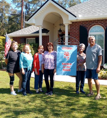 Gardenettes presented November Garden of the Month honors to Darlene and Damon Gaudet. Club members Darnell Kimber, Mary Hirsch, Karen Hotard, Darlene Kimber, Marilyn Wright, and Damon Gaudet pose with the club’s sign. (Photo by Vicky Fannaly)