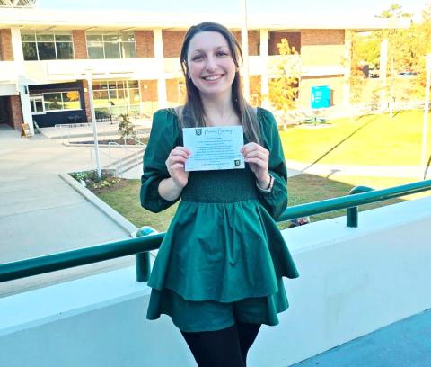 Southeastern education senior Kayla Simpson displays her certificate following the pinning ceremony on December 12, ahead of her final semester of teaching residency.