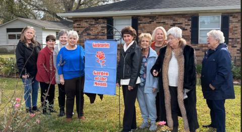 Pictured are Gardenettes Darnell Kimber, Karen Hotard, Sandy Cussick, President Susan Pizani, homeowner Sue Davis, Marilyn Wright, Kathy Bruce, Margaret Bailey, Ellen Pusey. ( Photo by Cricket Ayala)