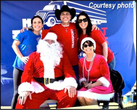 Joining Santa and Mrs. Claus at Roseland City Hall on December 20, 2025, are James Sparacello, flanked by his wife Sebrina (right) and his daughter Alexis (left). Transport Ministries set up to give away 1,000 toys to needful community members, along with clothing and food items.