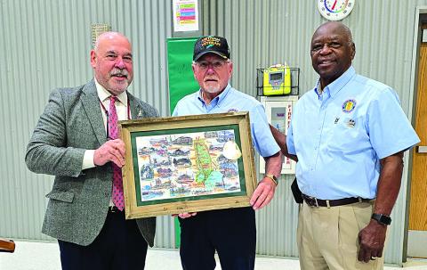 VVA Chapter 1052 presents a gift to guest speaker, Fernando Rivera Pictured, left to right: Guest speaker, Fernando Rivera; VVA Chapter 1052 president, Richard Neher; event emcee and coordinator, Parish Councilman, Louis Joseph, VVA Chapter 1052 (Tangi Times Photo)