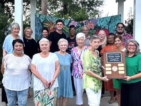 Photo by Virginia Hawkins Bottom Row: Gardenettes Vicky Fannaly, Susan Pizani, Linda Fabre, Margaret Bailey, Cricket Ayala presenting plaque to Leyla Hekmatdoost, Twin Steeples Executive Director. Top Row: Twin Steeples Board of Directors: Kim Zabbia, Ashley Gilless, Catherine Yoli, President Matt Barattini, Vice-President Trina Haynes, Treasurer Fred Trapp, Secretary Patti McGehee, Wanda Evans, Jodi Schaff, Marc Settembrino (not pictured - Lauren Fannaly).
