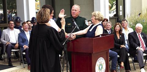 Gerald Sticker takes the Oath of Office, delivered by Judge Allison Penzato, as his wife, Tonia Sticker, and mother, Betty Sticker, hold the Bible (Tangi Times Photo)