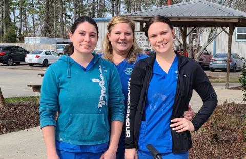 Tangipahoa Parish Animal Services (TPAS) girls, Daisy Voight, Dee Wilterberger, and Amber Huber, love their job of taking care of “the babies,” their affectionate nickname for their beloved shelter pets. Viewing themselves as foster parents of sorts, these wonderful girls work every day to find forever homes for the sweet animals in their care. Please call them at 985-543-0215 or visit https://tangipahoa.org/government/animal-services.