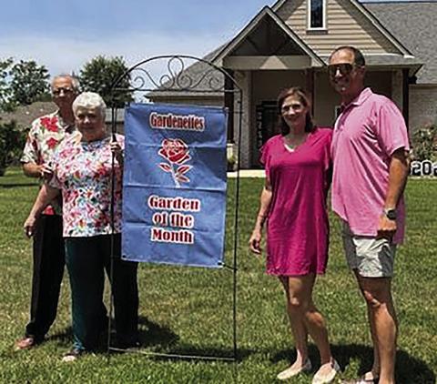 Kelly Pizani and Dominic Miceli (right) receive Garden of the Month for May from Gardenettes, a Ponchatoula garden club. Attending the ceremony at the Rue Chateau residence in Belle Foret were (at left) Tillman Pizani and Gardenette president, Susan Pizani.