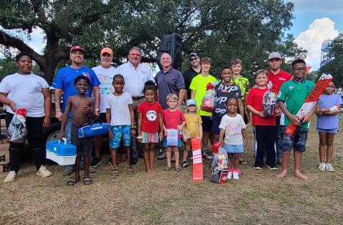 Winners show off rodeo prizes Winners of competition prizes and door prizes proudly pose with their spoils. In the back row are James Sparacello (Transport Ministries), James Harris (event host, Kids Church in the Park), Chris Gideon, Chris Geraci (American Bank), and Patrick Landry (American Bank).