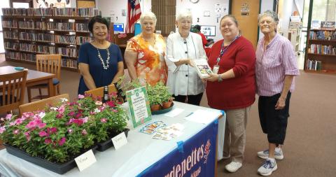At last year’s National Garden Week, the Gardenettes sponsored a free plant, seed, and gardening book giveaway. Shown are garden club members Vicky Fannaly, president Susan Pizani, Margaret Bailey, librarian Kristen Breland, and Gardenette Sunday Hanson. (Courtesy Photo)