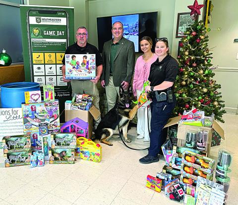 From left: Lt. Ronald Plaisance, Southeastern President Dr. William Wainwright, Southeastern student worker Katie Randall, K-9 Jula, and Sgt. Michelle Blanchard (Courtesy Photo)