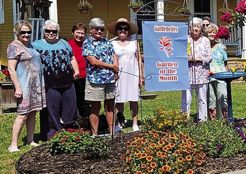Anita Brandon, 163 S. Fifth St., receives June Garden of the Month honors from the Gardenettes. Shown are garden club members Jamie LeBlanc, Susan Pizani, Virginia Hawkins, homeowner Anita Brandon, Sandy Cusick, Margaret Bailey, Cricket Ayala, Marilyn Wright. (Courtesy Photo)
