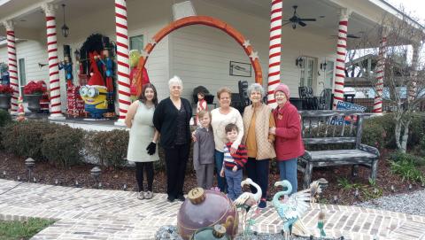 Bonnye and Mike Wills received Garden of the Month for December from the Gardenettes. Shown are Marissa Pizani, Susan Pizani, Leasel Malone, Bonnye Wills, Brodie Malone, Marilyn Wright, and Karen Hotard. Photo by Vicky Fannaly.