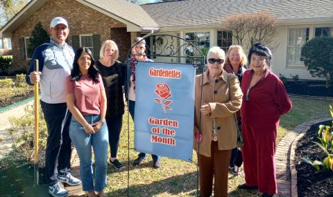 Homeowners Chance Enmon and Hazel Enmon accept Garden of the Month honors from Gardenettes Kathy Bruce, Cricket Ayala, Susan Pizani, Mary Hirsch, and Vicky Fannaly. Present but not shown were Margaret Bailey and Tillman Sterken, photographer. (Courtesy Photo)