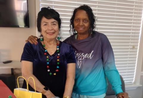 Gardenette Vicky Fannaly, left, delivers holiday ornaments to Deborah Haynes, coordinator, at Westminster Place, a senior apartment complex for their Christmas dinner event.