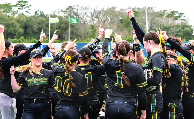 Southeastern softball ladies huddle up during a glorious Mardi Gras Mambo performance (Photo courtesy of Arief Harlan )