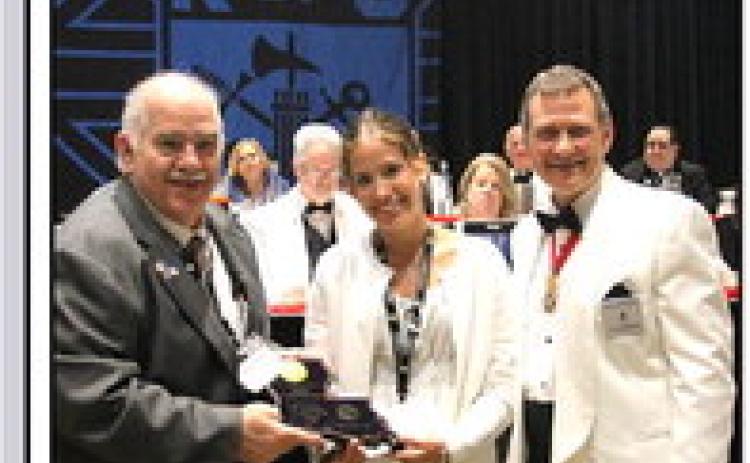 K of C State CYLA Chairman Delmas Forbes (left) and State Deputy Bobby Charpentier (right) present Hunter Grace Layrisson with a plaque and a $5000 check