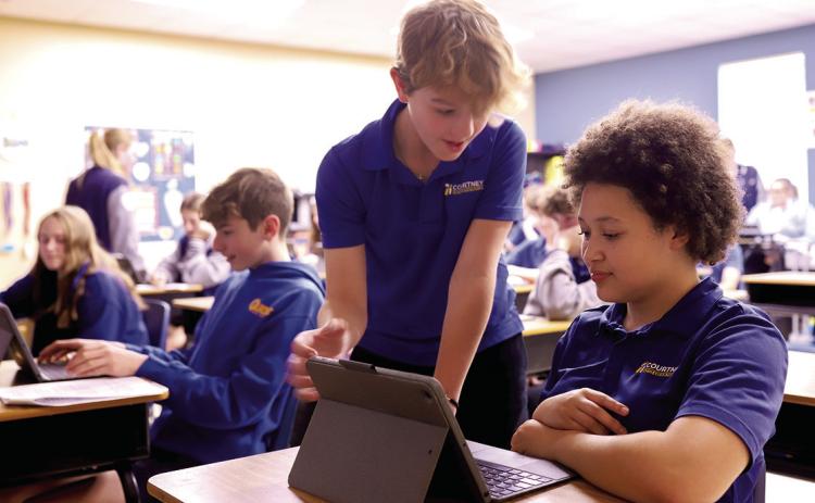 Eighth-grade students, Josiah Webre and Jada Hart, work diligently in language class (Photo Courtesy of Angie Johnson, CCS)
