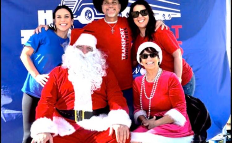 Joining Santa and Mrs. Claus at Roseland City Hall on December 20, 2025, are James Sparacello, flanked by his wife Sebrina (right) and his daughter Alexis (left). Transport Ministries set up to give away 1,000 toys to needful community members, along with clothing and food items.