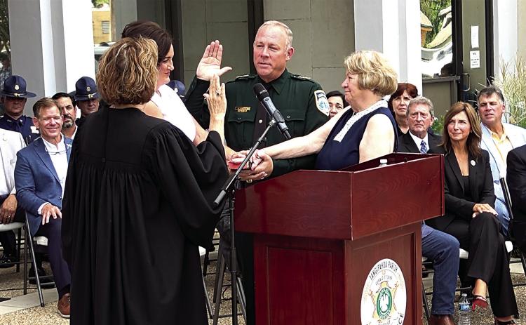 Gerald Sticker takes the Oath of Office, delivered by Judge Allison Penzato, as his wife, Tonia Sticker, and mother, Betty Sticker, hold the Bible (Tangi Times Photo)