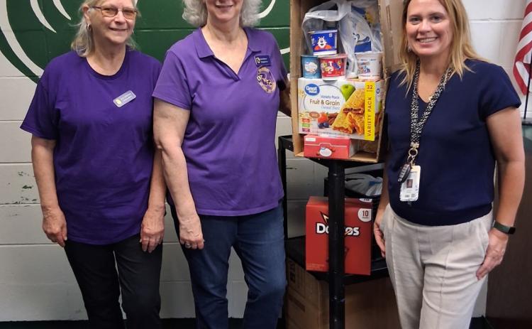 WVFC members, Jean Johnson and Jean Hebert deliver donations to a Ponchatoula High School Administrator. (Courtesy photo)