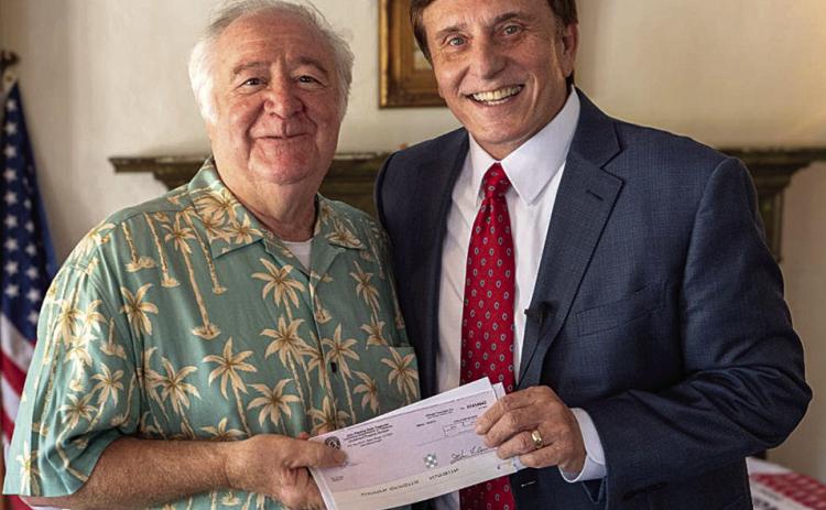 LA State Treasurer John Fleming (right) personally delivered an unclaimed money check to Alessandro Pieri (left) last Tuesday. (Courtesy Photo)