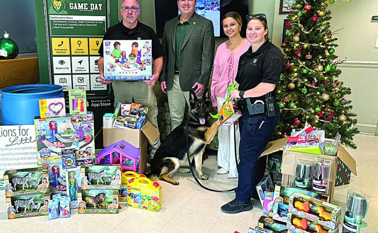 From left: Lt. Ronald Plaisance, Southeastern President Dr. William Wainwright, Southeastern student worker Katie Randall, K-9 Jula, and Sgt. Michelle Blanchard (Courtesy Photo)