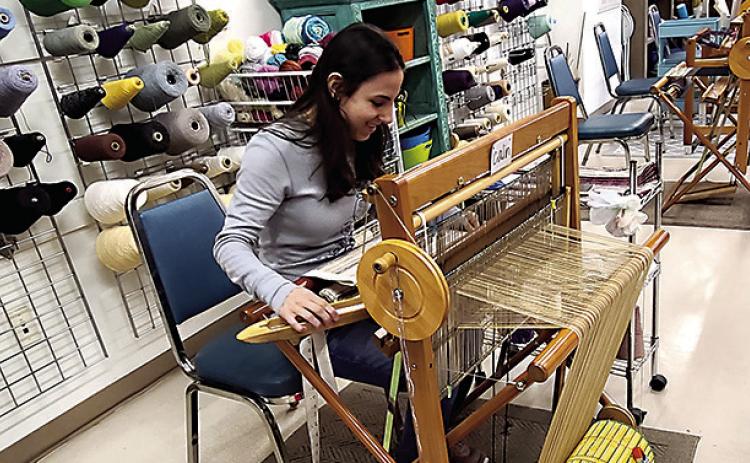 Weaving specialist, Calin, uses an old-world loom to create fabrics of her chosen design. Each panel of fabric will be cut and sewn into beautiful saleable products, such as towels, table runners, and wine bags. (Tangi Times Photo)