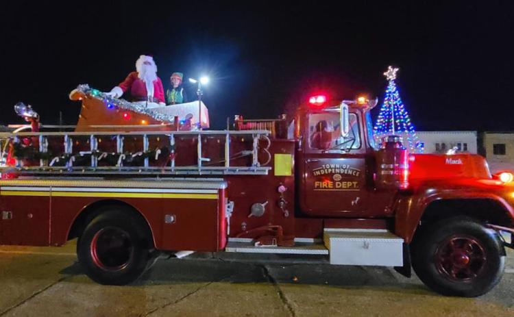 Santa and his elf pose after the Independence Christmas parade in front of the town’s Christmas tree in the heart of historic Independence. Tangi Times Photo