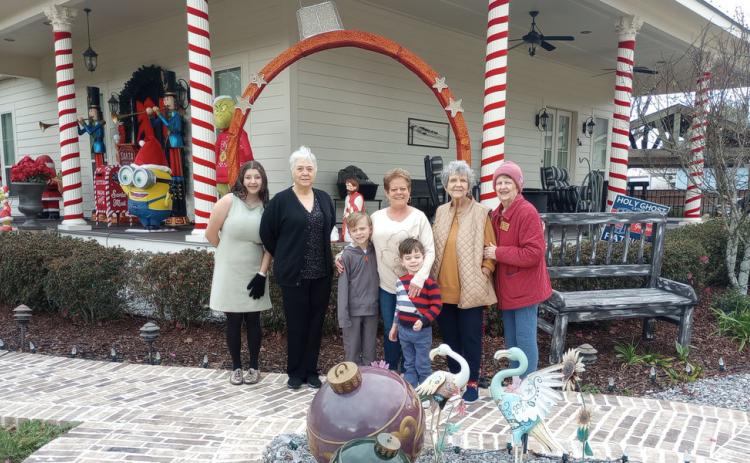 Bonnye and Mike Wills received Garden of the Month for December from the Gardenettes. Shown are Marissa Pizani, Susan Pizani, Leasel Malone, Bonnye Wills, Brodie Malone, Marilyn Wright, and Karen Hotard. Photo by Vicky Fannaly.